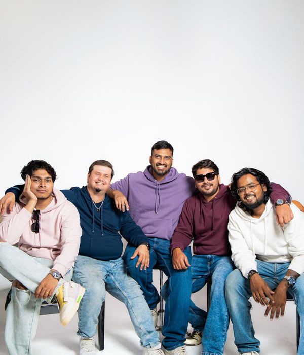 Diverse group of people smiling and looking relaxed in a modern studio.